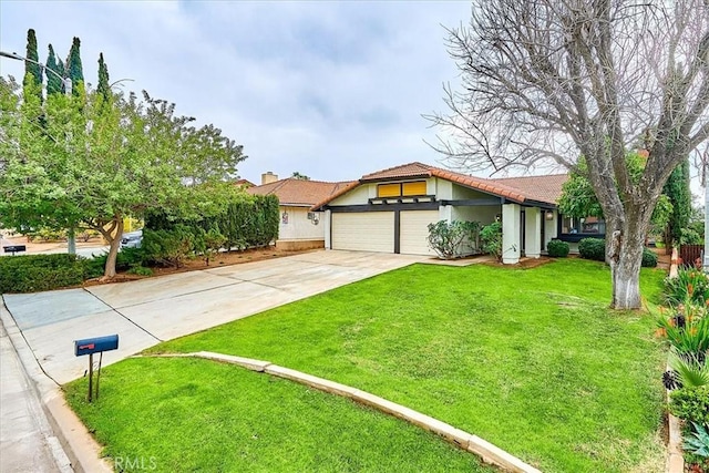 view of front of house featuring a garage and a front lawn