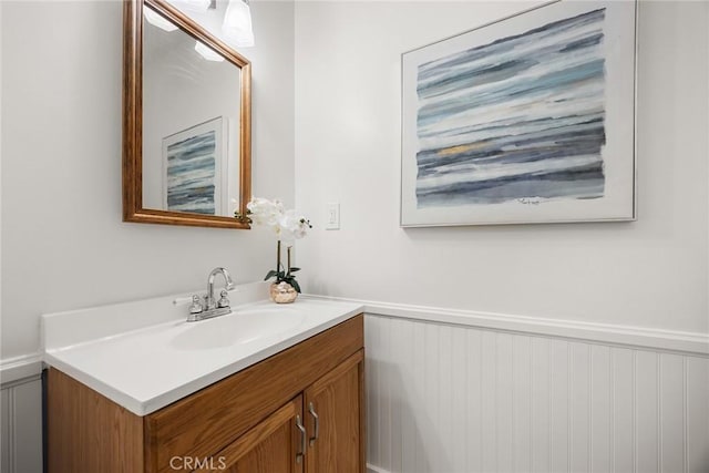 bathroom featuring a wainscoted wall and vanity