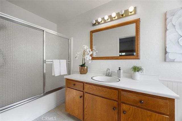 bathroom featuring vanity, tile patterned floors, and shower / bath combination with glass door