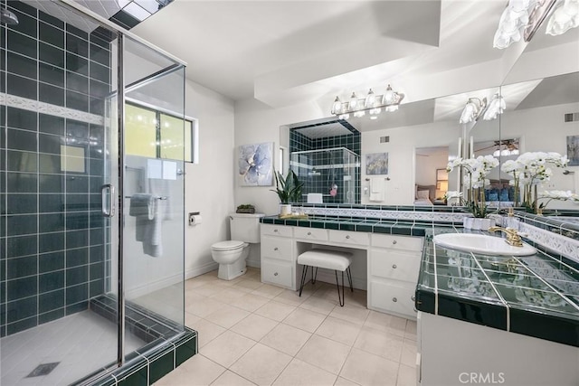 bathroom featuring vanity, an enclosed shower, tile patterned floors, and toilet