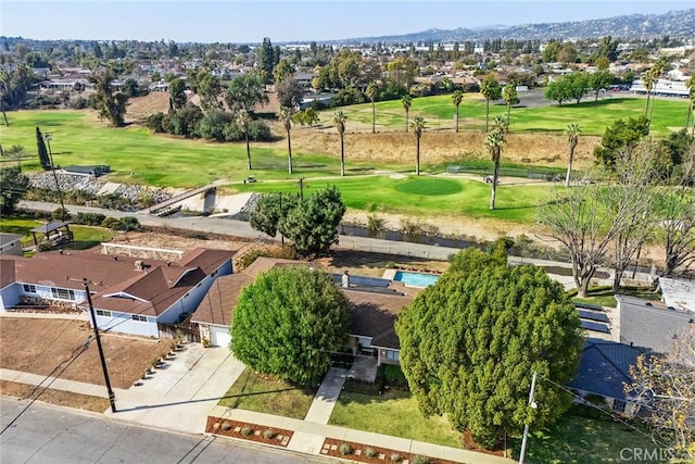 birds eye view of property with view of golf course and a residential view