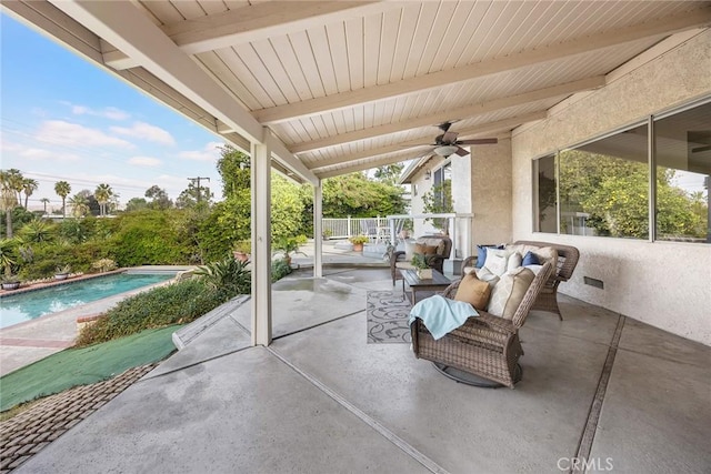 view of patio / terrace featuring ceiling fan, an outdoor living space, and a fenced in pool