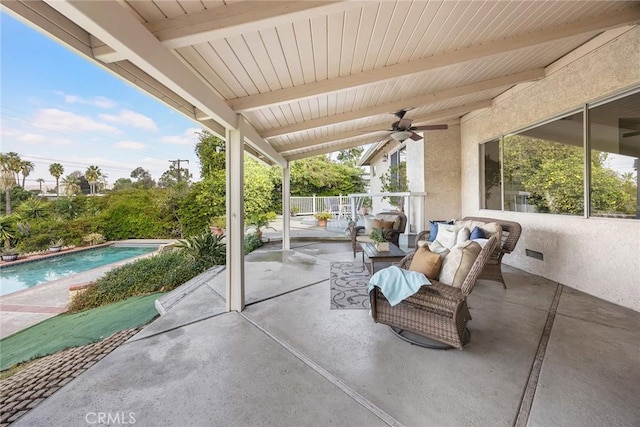 view of patio with ceiling fan and an outdoor pool