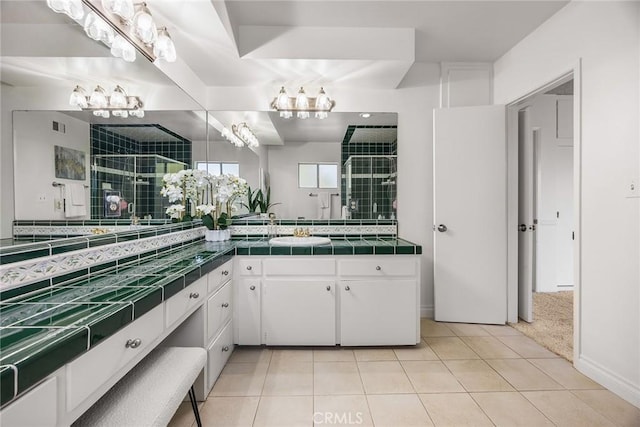 bathroom featuring walk in shower, tile patterned floors, and vanity