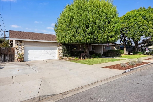 ranch-style home with a garage and a front lawn