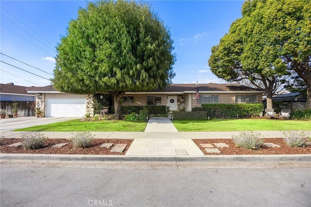 ranch-style home with a garage, a front lawn, and concrete driveway