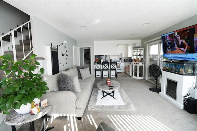 carpeted living room with a textured ceiling