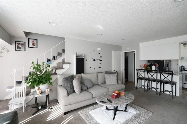 living room featuring a textured ceiling and carpet flooring