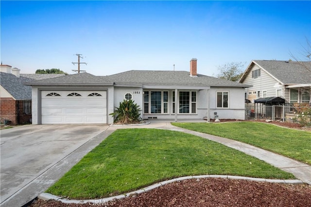 view of front of property with a garage and a front yard