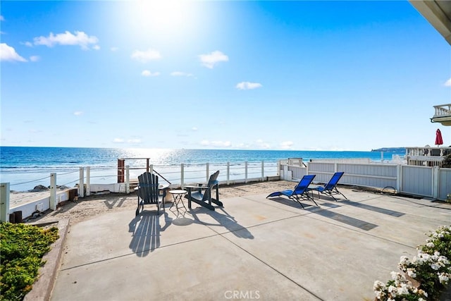 view of patio featuring a view of the beach and a water view