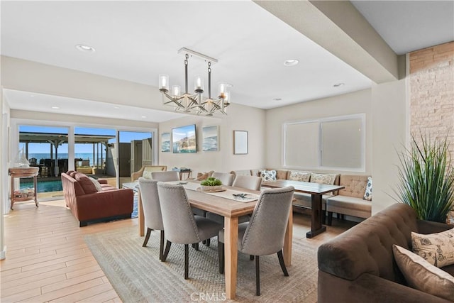 dining area featuring a chandelier and light hardwood / wood-style flooring