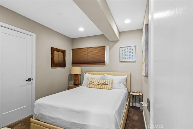 bedroom featuring dark carpet