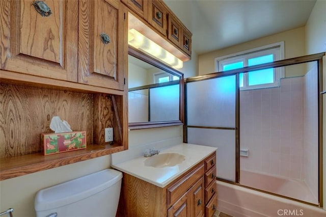 full bathroom with vanity, toilet, and combined bath / shower with glass door