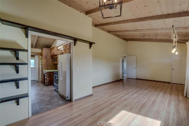 kitchen featuring white refrigerator, hardwood / wood-style flooring, lofted ceiling with beams, and wooden ceiling