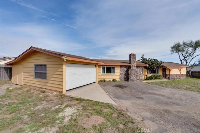 ranch-style home featuring a garage