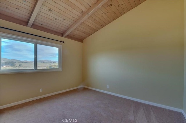 carpeted spare room featuring lofted ceiling with beams, a mountain view, and wooden ceiling