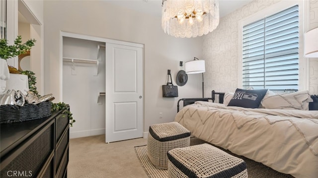 carpeted bedroom featuring a notable chandelier