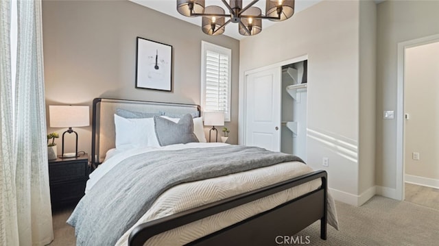 bedroom featuring light colored carpet, an inviting chandelier, and a closet