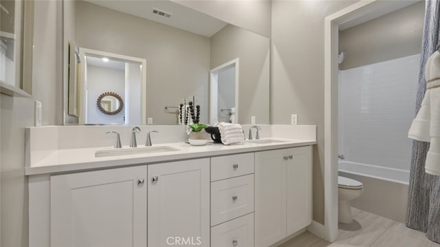 full bathroom with vanity, toilet, and shower / tub combo with curtain