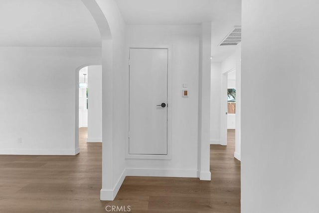 hallway with dark hardwood / wood-style flooring