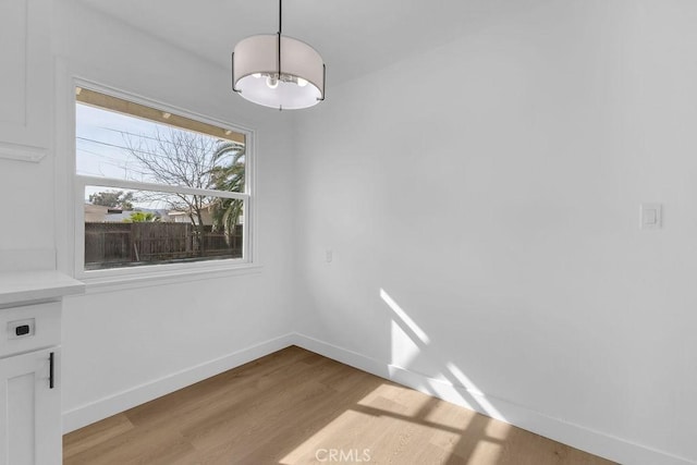 unfurnished dining area featuring light hardwood / wood-style flooring