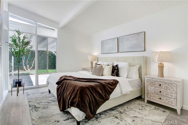 bedroom with vaulted ceiling with beams, access to outside, and light hardwood / wood-style floors