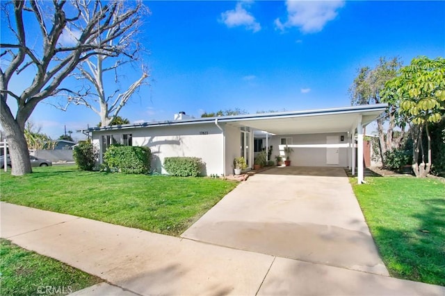 view of front facade featuring a front yard and a carport