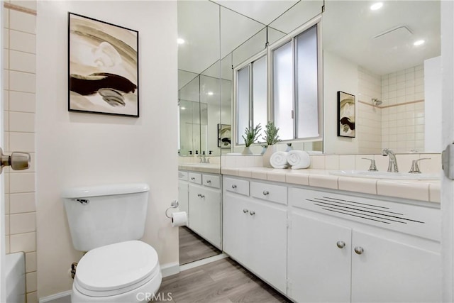 bathroom with vanity, wood-type flooring, and toilet