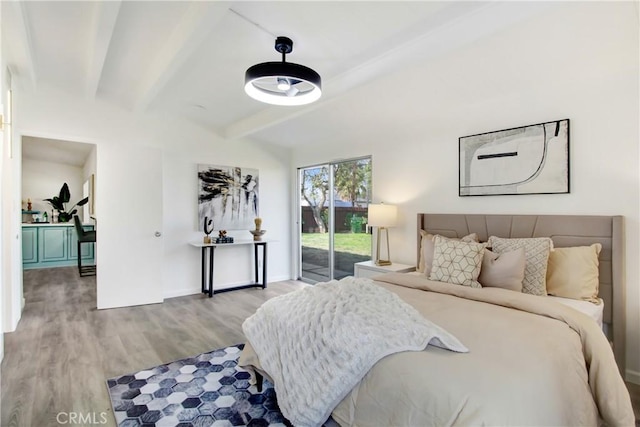 bedroom featuring access to outside, light hardwood / wood-style floors, and beamed ceiling