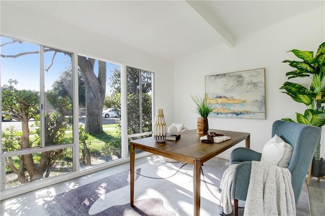 home office featuring concrete flooring and vaulted ceiling with beams