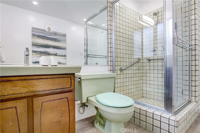 bathroom featuring walk in shower, vanity, and toilet