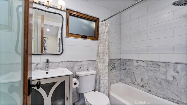 full bathroom with vanity, tile walls, shower / bath combination with curtain, and toilet