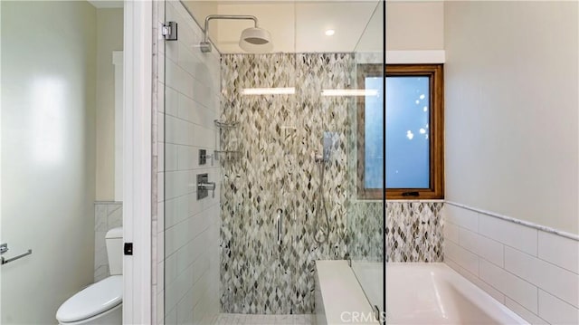 bathroom featuring separate shower and tub, tile walls, and toilet