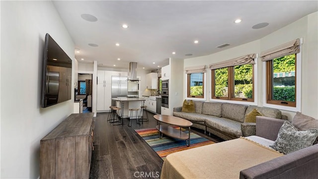 living room with dark hardwood / wood-style flooring