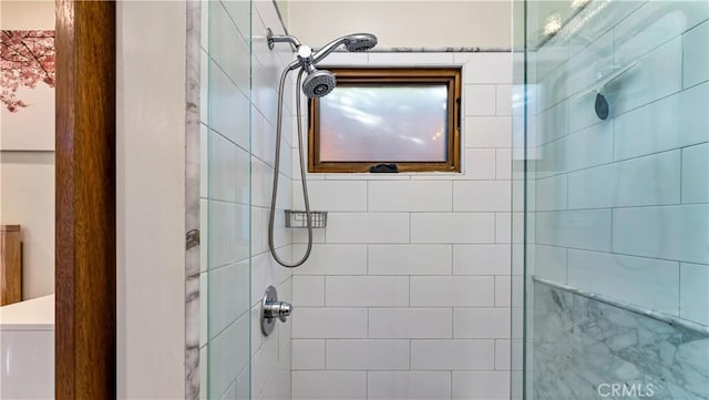 bathroom with tiled shower