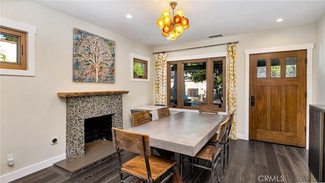 dining area with an inviting chandelier and dark hardwood / wood-style floors