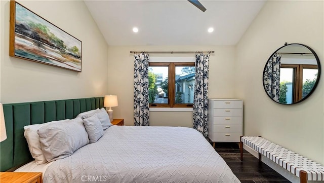 bedroom featuring dark hardwood / wood-style flooring, vaulted ceiling, and ceiling fan