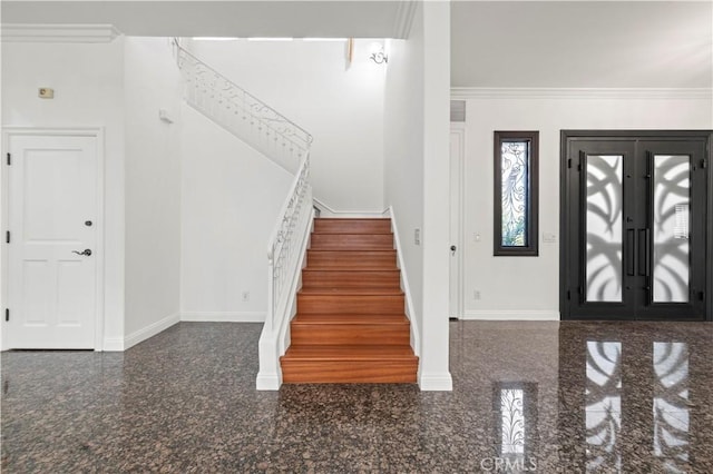 entrance foyer with ornamental molding and french doors