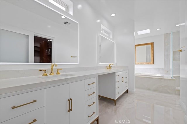 bathroom featuring vanity and a washtub