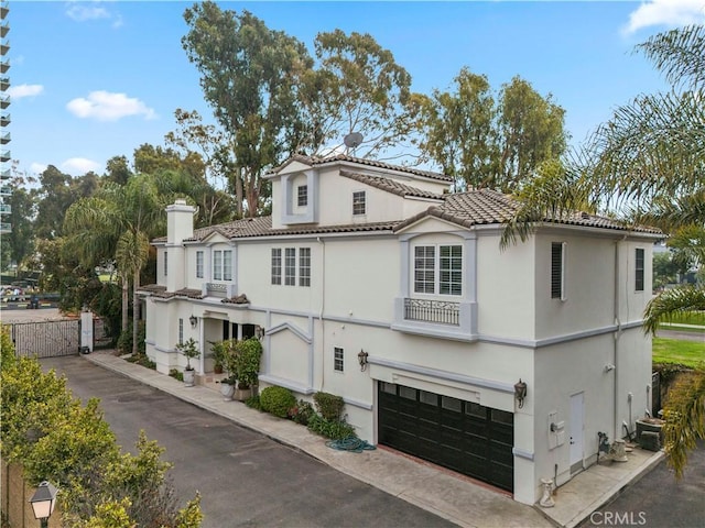 mediterranean / spanish-style home with a garage