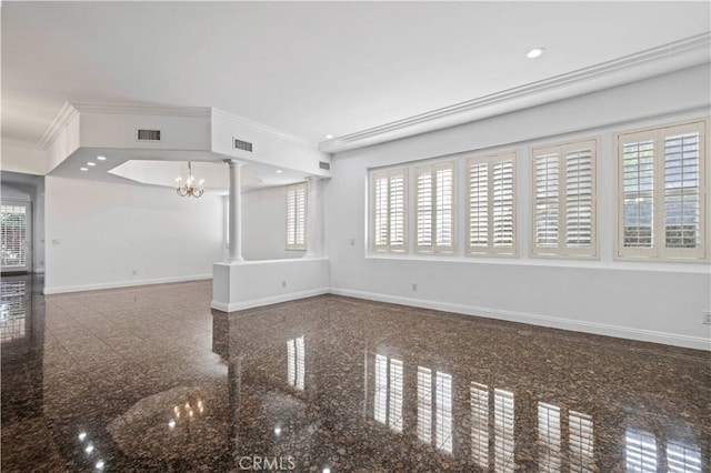 unfurnished living room featuring crown molding, a chandelier, and ornate columns