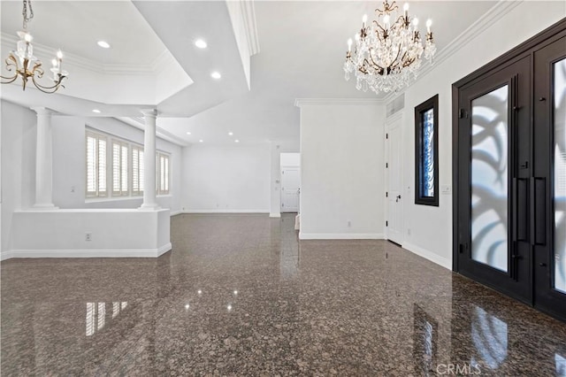 entrance foyer with ornate columns, crown molding, and a notable chandelier