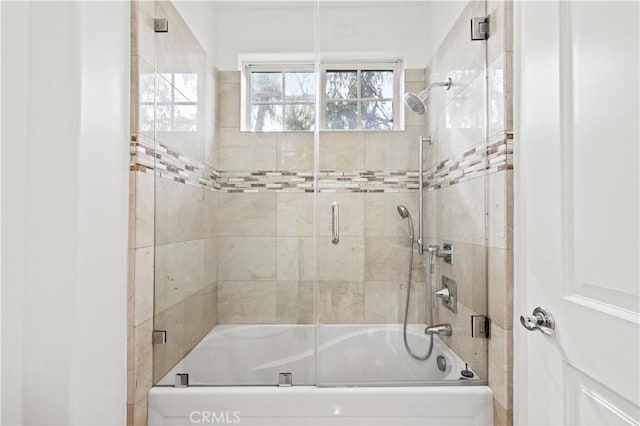 bathroom featuring shower / bath combination with glass door