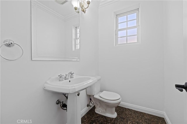 bathroom with crown molding and toilet