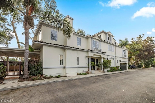 view of front of property with a garage and a carport