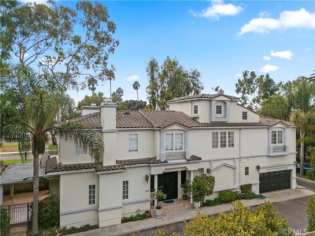 mediterranean / spanish home featuring a garage