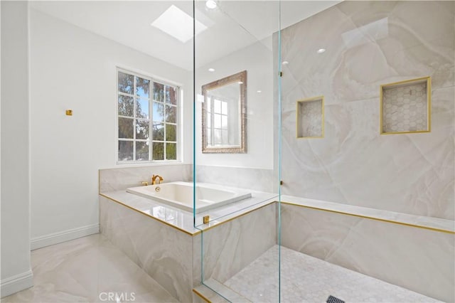 bathroom featuring a skylight and independent shower and bath