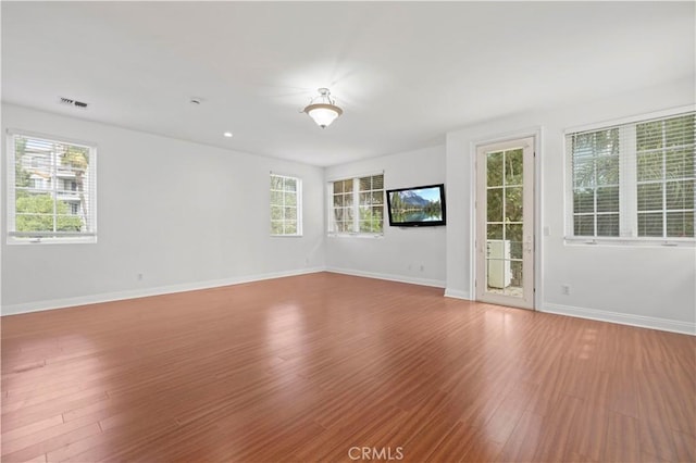 empty room with hardwood / wood-style flooring