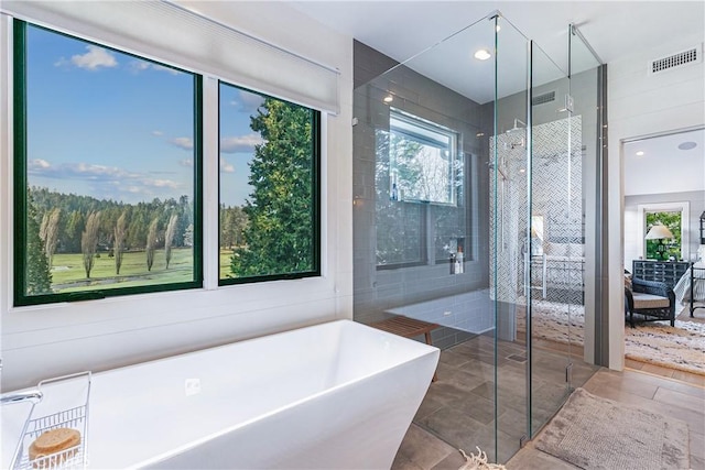 bathroom featuring tile patterned floors and shower with separate bathtub