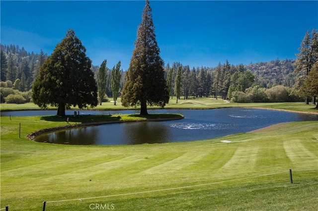 surrounding community with a lawn and a water view